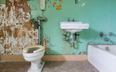 Old bathroom in need of renovation Old bathroom and toilet needs some renovation work inside Trans-Allegheny Lunatic Asylum in Weston, West Virginia, USA